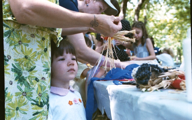 child making straw doll horizontal